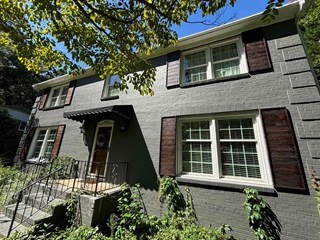 Shutters after they have been stained, giving them a polished, finished look. The shutters now match the aesthetic of the house and enhance its overall appearance.