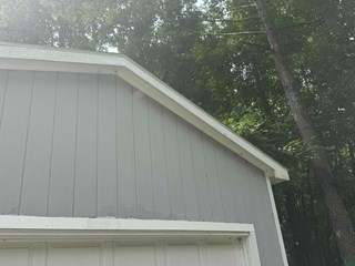he damaged area has been replaced with new materials, and the fascia now looks solid and in better condition. The white trim is freshly painted, and the overall appearance is much improved.