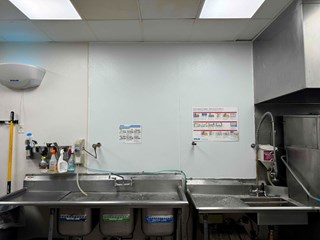 Restaurant kitchen wall has been repaired with Fiberglass Reinforced Plastic to prevent future water damage. 