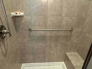 Tile shower after a grab bar has been installed.
