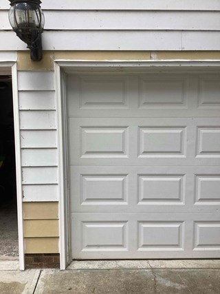 Post repair trim is now fresh and clean, with a fresh coat of paint, and the siding looks much more polished.