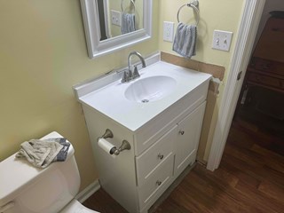 Bathroom vanity with an incomplete backsplash.