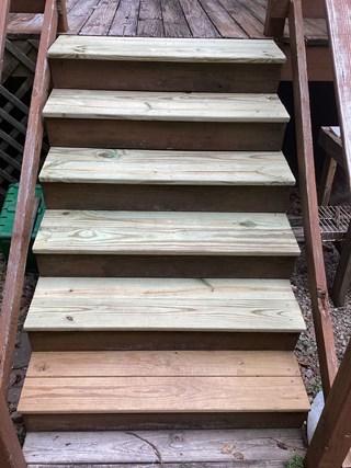 set of stairs after being repaired. The old, damaged boards have been replaced.