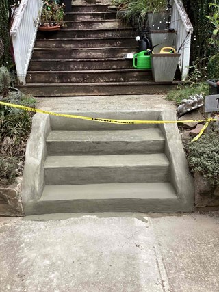 Steps after they have been repaired and resurfaced. The steps are now smooth and even, with a fresh concrete layer, providing a clean, durable, and safe surface.