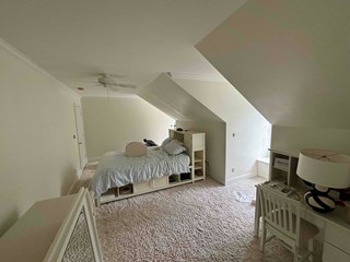 Bedroom with the walls and ceiling repainted in a neutral light color.