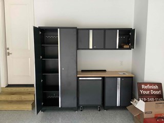 Garage area after it has been transformed with a set of neatly assembled cabinets, providing storage and organization.