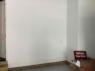 Empty wall area with just a door and some basic features and no organizational space. 