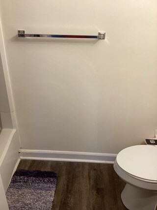 Bathroom wall after the drywall repair has been completed. 