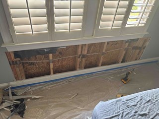 Drywall that was removed beneath a window after a leak.  