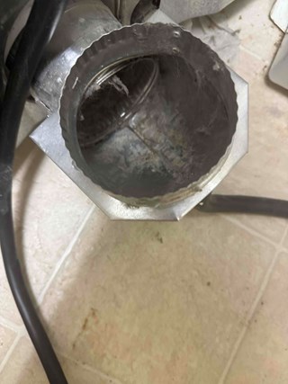 Dryer duct after being cleaned, with the lint removed and the area clear and safe.