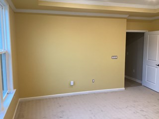 The same room, now painted with a warm, yellow color on the walls.