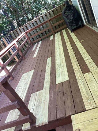 The damaged sections of the deck boards have been removed and replaced.
