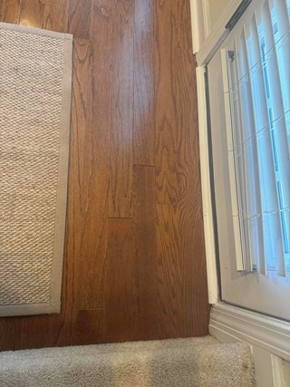 The damaged wood flooring has been replaced with fresh, undamaged planks.