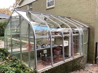 Greenhouse after repairs. The panels are now cleaner, and the gaps between the frame and the panels have been sealed properly.