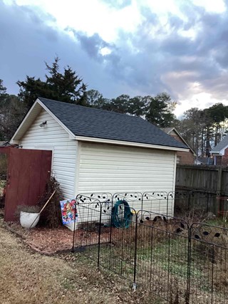 Shed, with the wall repaired and in a much cleaner, undamaged condition.