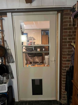 Pittsboro storm door with doggy door after replacement