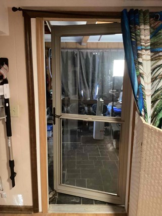 Old storm door in the 27312 zip code before replacement 
