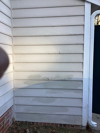 Masonite siding showing signs of damage needing to be replaced by a local handyman.
