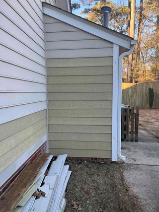 Side of house after partial siding replacement has been made  in Raleigh 
