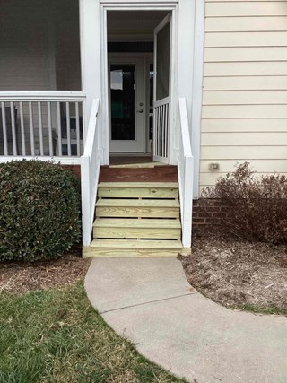 Newly constructed wooden steps replacing old, weathered ones