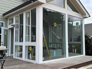Pella windows being installed in a new sunroom addition