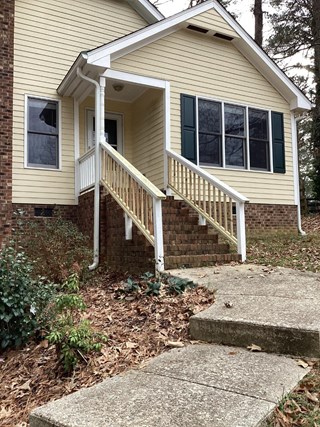 Newly installed exterior wood railing by Ace Handyman Services