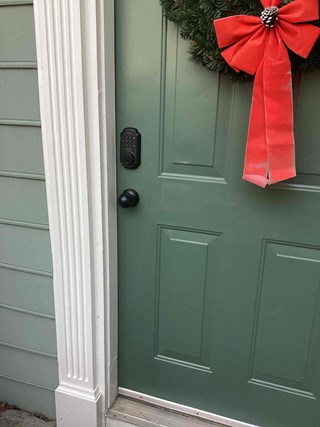 Professional installation of a digital keypad door lock.