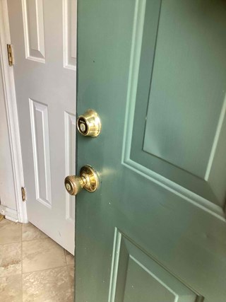 Before photo of a door lock prior to professional lock replacement service