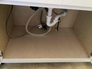 New cabinet base installation under a sink, demonstrating professional carpentry and craftsmanship in Cary 27511. 