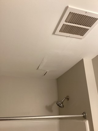 Bathroom ceiling requiring repair due to water damage and peeling paint in Raleigh 27603. 
