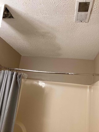 Bathroom popcorn ceiling in Durham, NC after popcorn ceiling repair due to water damage in ceiling. 