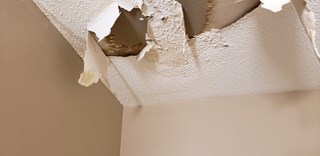  Popcorn ceiling damage in Durham, NC home. Peeling texture and signs of water intrusion.