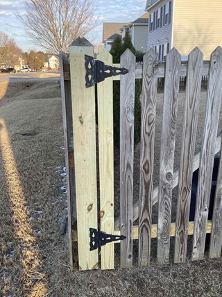 Professional fence gate repair with new pressure-treated lumber in Clayton, NC. Sturdy and durable gate restoration.