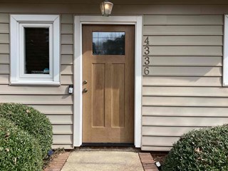 Front exterior of a single-family home in Raleigh, NC 27604 before replacement by Ace Handyman Services
