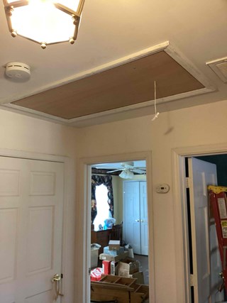 After photo showcasing the finished attic ladder installation. The closed hatch blends seamlessly with the ceiling, providing easy and discreet access to the attic.