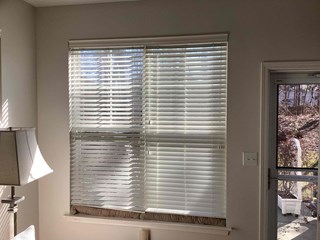 indow treatment project: before photo of a window with blinds in Raleigh, NC 27613. Prepped for curtain installation, with natural light highlighting the space.