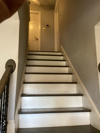 Before photo of dark-stained tread and white riser stairs in Raleigh, NC, without a handrail.