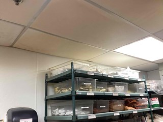 Morrisville, NC, restaurant before ceiling tile repair: stained and damaged tiles in kitchen. Image shows need for commercial ceiling repair and maintenance.