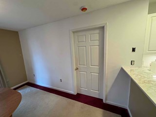  Raleigh, NC 27614, home after drywall repair and door installation: smooth repaired walls and a new prehung interior door.