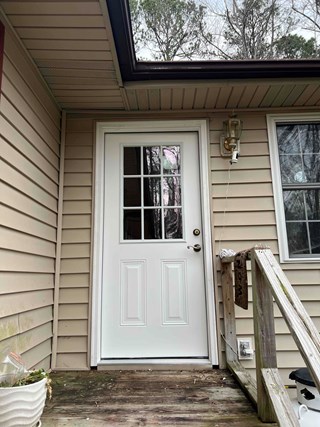 After photo of a new 32" x 80" exterior door installation in Raleigh, North Carolina, featuring a 9-lite prehung door. Highlighting door replacement and home improvement.