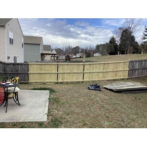 Wooden-Fence-With-Four-New-Panels-After-Repair