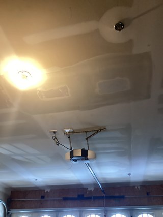 Large-Hole-in-ceiling-drywall-above-garage-after-professional-repair
