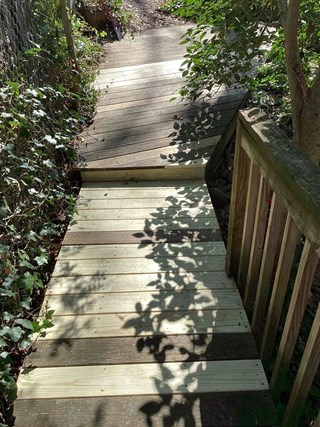 wood-deck-stairs-with-new-planks-after-professional-repair