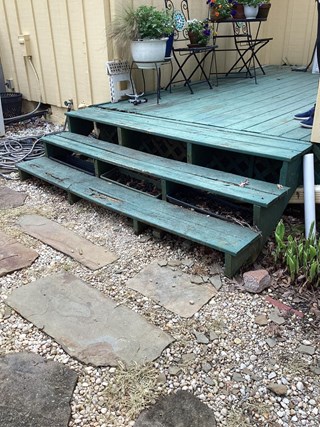 Green-porch-steps-with-visible-wood-rot