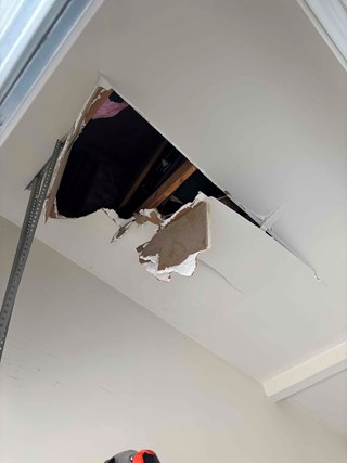 Hole-in-garage-ceiling-drywall-damage
