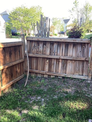 wooden fence showing signs of damage and leaning