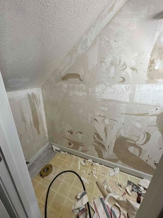 Half bath renovation in progress, old dated flooring is visible.  The room needs drywall repair, new paint, and new flooring in Fuquay-Varina NC 27526
