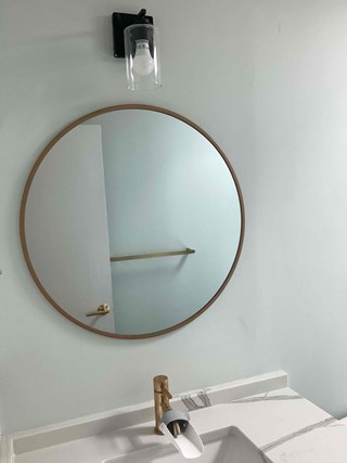 Completed bathroom repairs, painting, and a new round mirror hung after repairs in Chapel Hill NC 27514