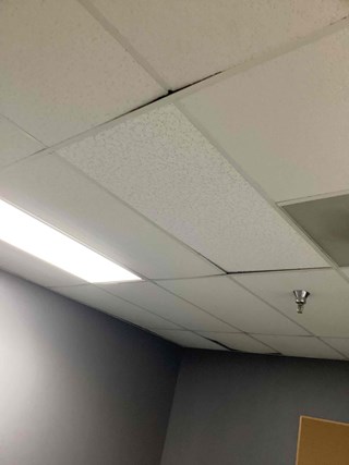 Commercial Ceiling Tile requiring facility maintenance due to water damage after replacement Durham NC 27713