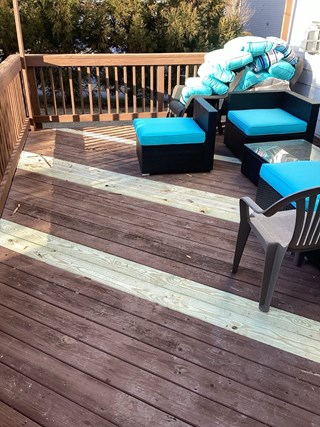 Repaired wood deck in Cary, NC 27519 by Ace Handyman Services, showing replaced boards and restored structure.